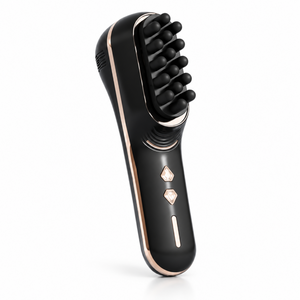 Black scalp massage comb with metallic trim on a clean white background