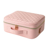 Pink quilted makeup case with zip closure on a white background