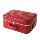 Red quilted makeup case with zip closure on a white background