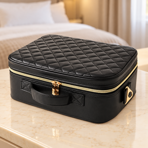 Black makeup case displayed on a warm neutral hotel dressing table