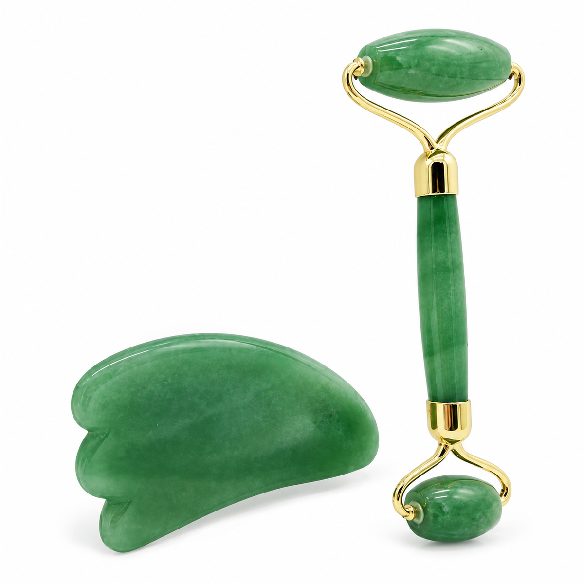Green facial roller and gua sha on a white background