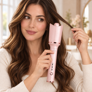 Automatic Rotating Hair Curler held beside a section of hair before styling