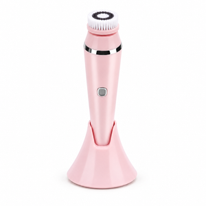 Pink facial cleansing brush on a white background