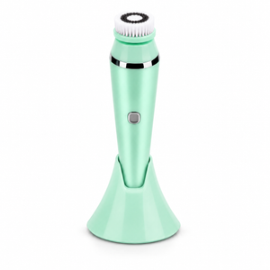 Mint green facial cleansing brush on a white background