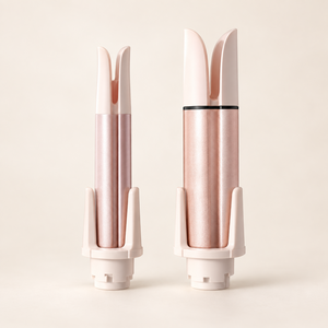 The two spare interchangeable 28mm and 32mm curling barrels in pink and rose gold.