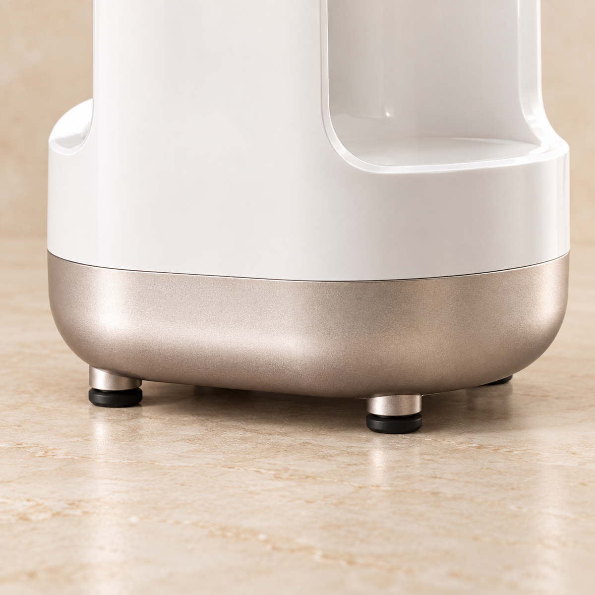 Close-up of the makeup brush cleaner base with rose-gold detailing on a stone vanity.