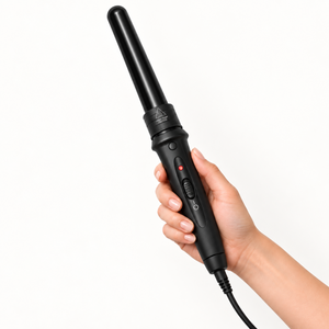 Hand holding the black curling wand with one ceramic barrel attached, showing the slider control and red indicator.