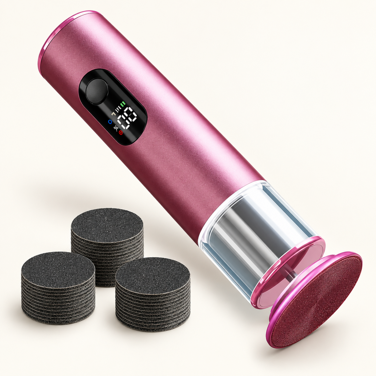 Pink rechargeable foot file with replacement abrasive discs arranged beside it.