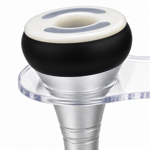 Detail of the vacuum handpiece showing its white rim, hollow centre, black collar and silver handle.