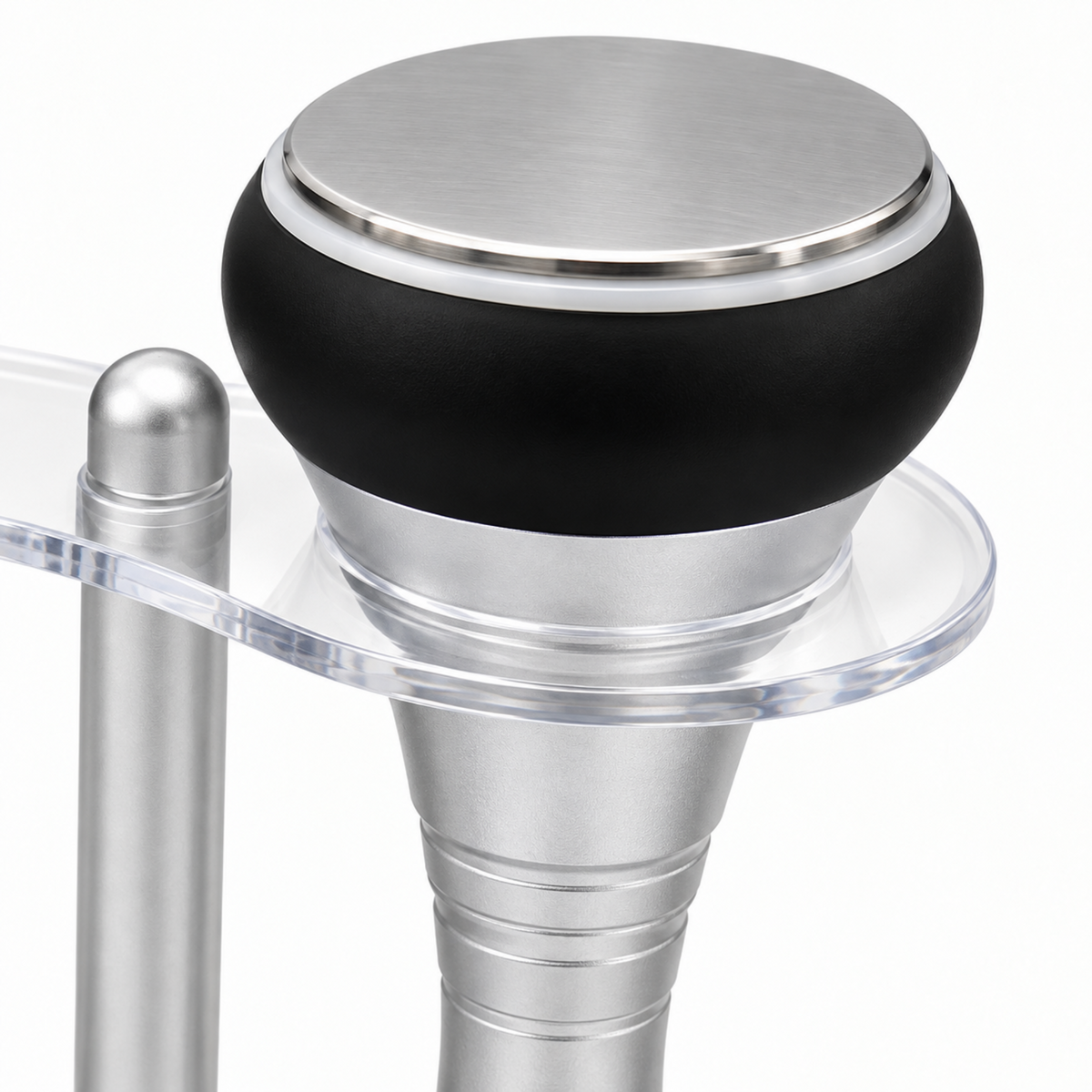 Detail of the flat circular ultrasound handpiece with silver disc, black collar and clear holder.