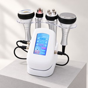 Four-in-one beauty console with all four handpieces displayed on a pale studio platform.