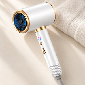 White and gold hair dryer on a neutral surface beside an ivory towel