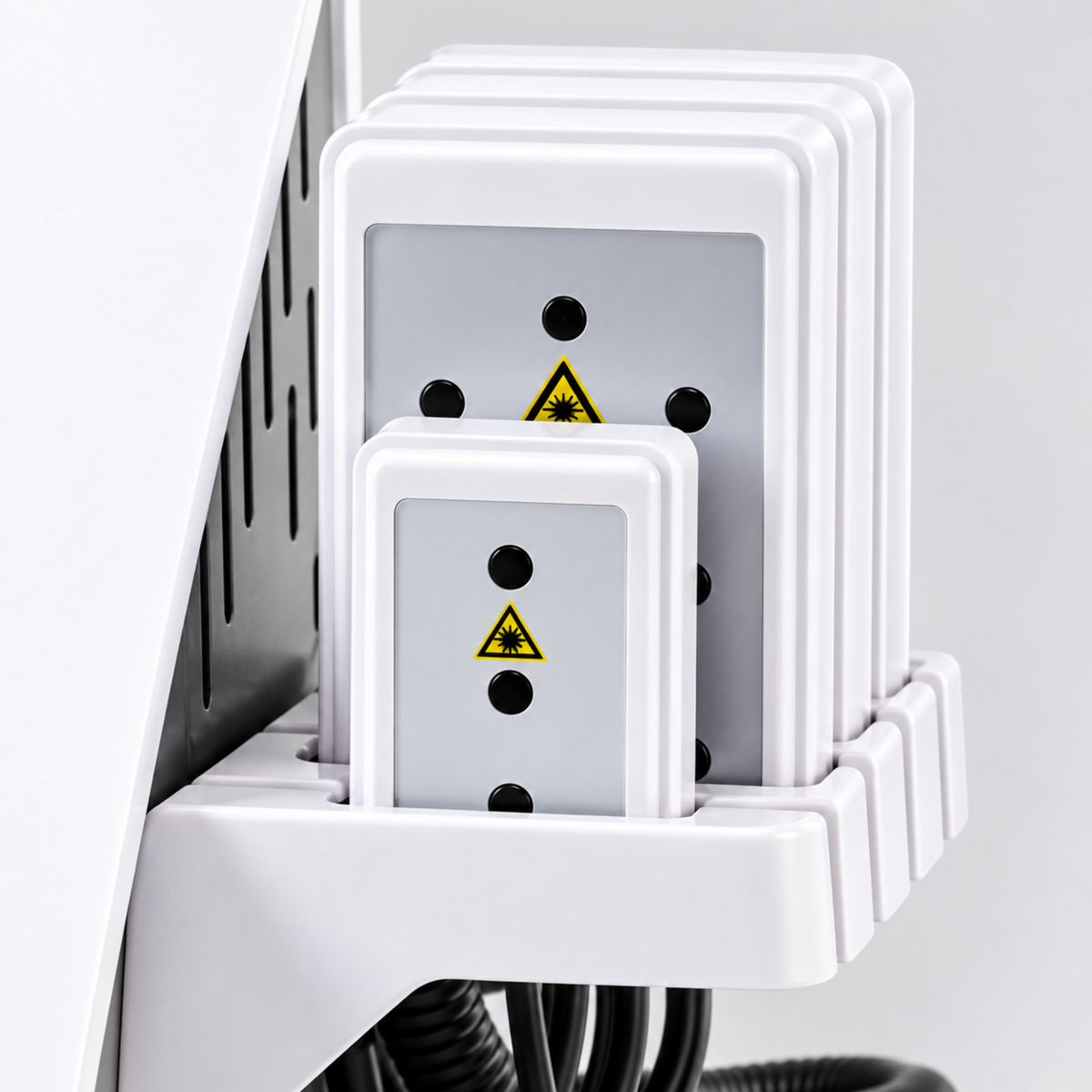 Close-up of the applicator plates and their storage holder, with safety markings visible