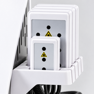 Close-up of the applicator plates and their storage holder, with safety markings visible