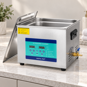 15-litre ultrasonic cleaner with its steel lid on a neutral salon utility counter.