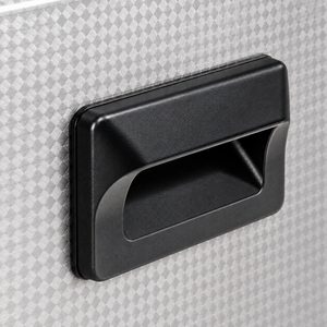 Close-up of the black recessed carrying handle and textured stainless steel housing.