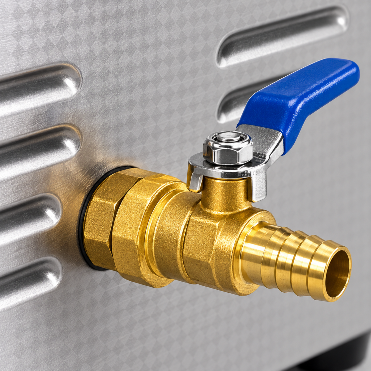 Detail of the brass drain valve with its blue lever and ridged outlet on the ultrasonic cleaner.