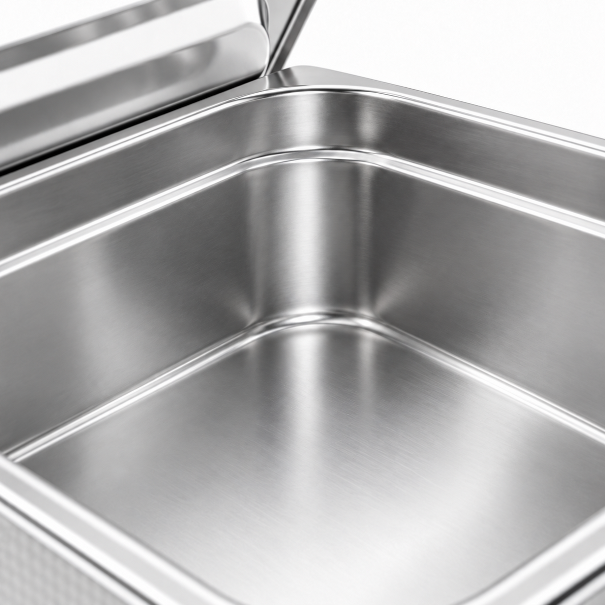 Close-up of the empty stainless steel tank and polished rim, with the removable lid behind it.