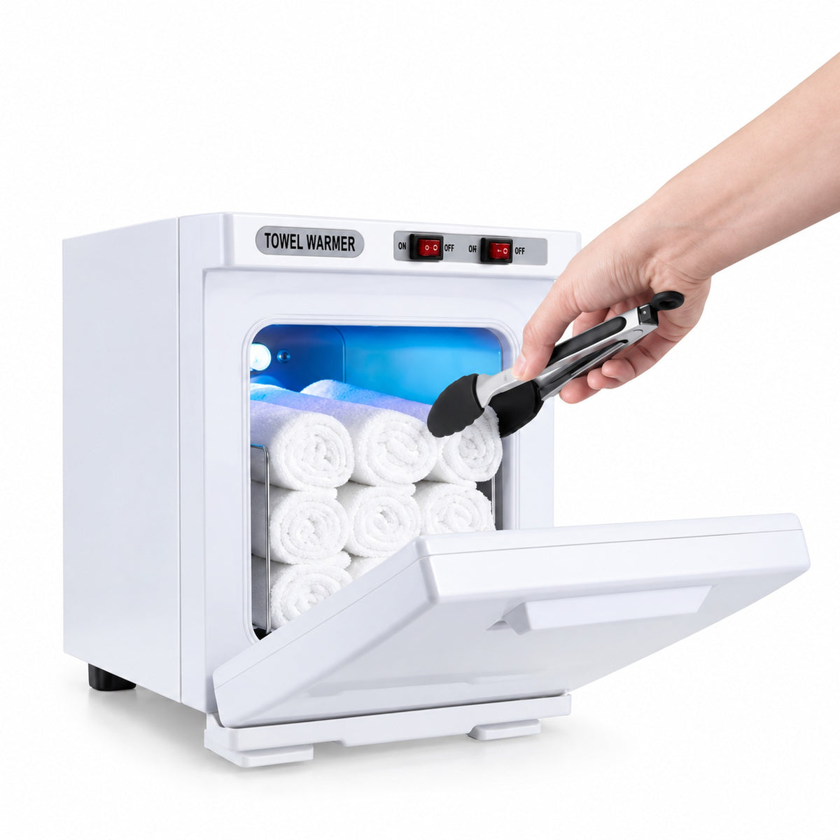 Open white towel warmer with a hand using tongs to handle a towel; towels and tongs shown for illustration