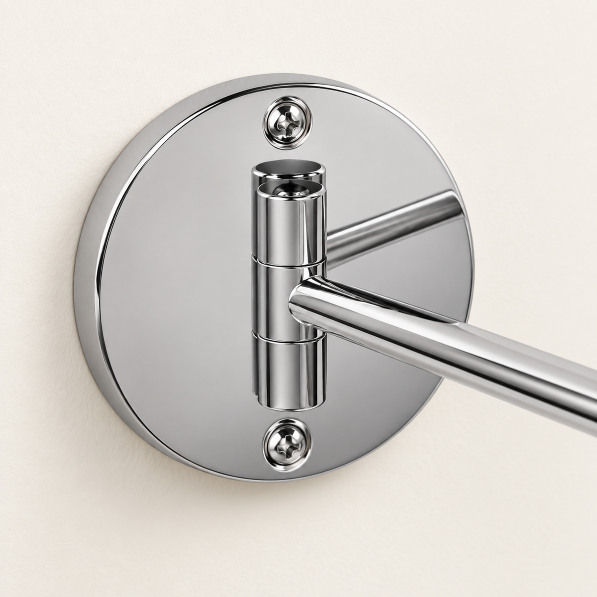 Close-up of the chrome wall mounting plate and two fixing screws